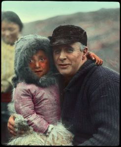 Image of MacMillan and Eskimo child, mother beyond